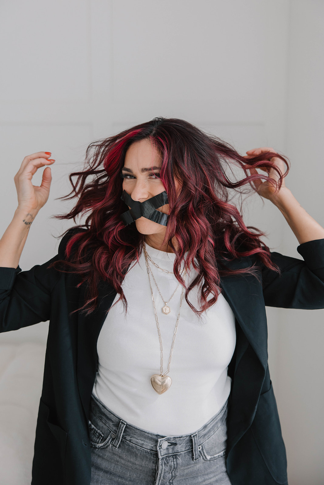 Michelle Castro — tape over mouth, hair wild, eyes alive